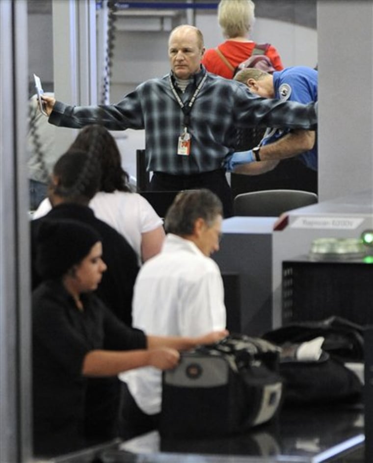 An air traveler is patted down by a TSA agent Monday at O'Hare International Airport in Chicago.